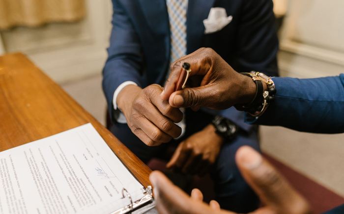 Two professionals finalizing a signed agreement