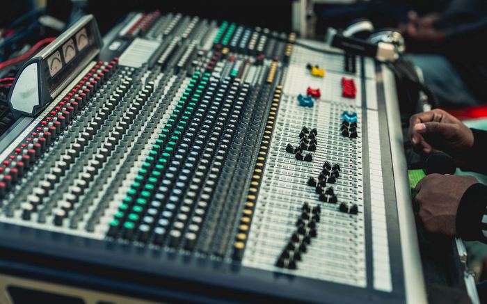 Sound engineer working closely with equipment in a studio