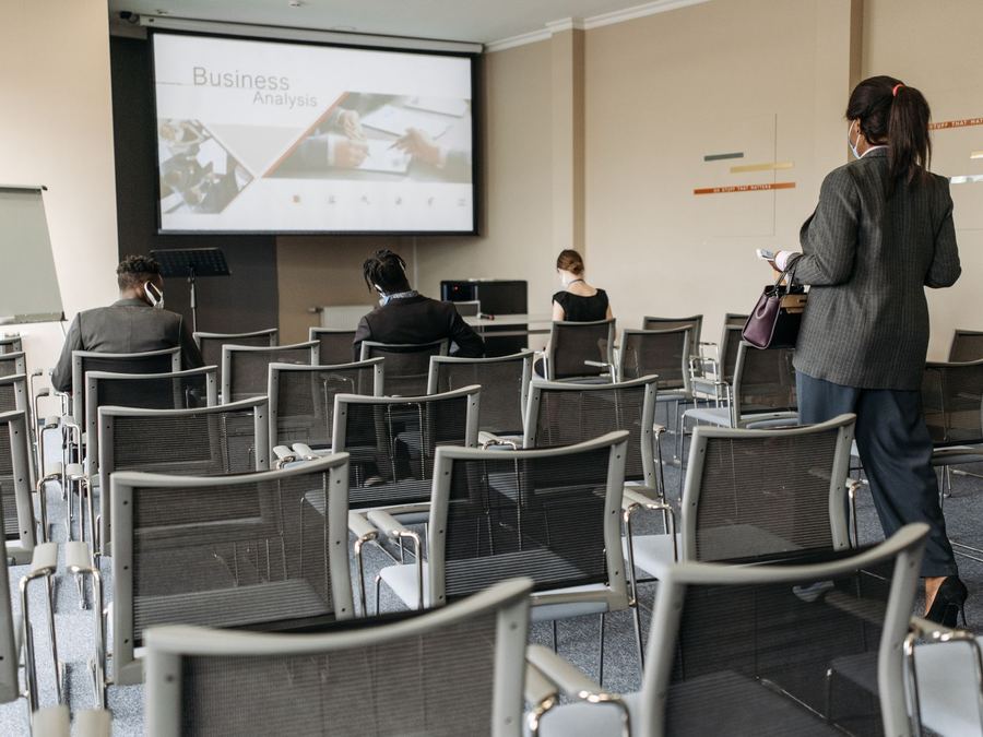 Attendees seated in a conference room session